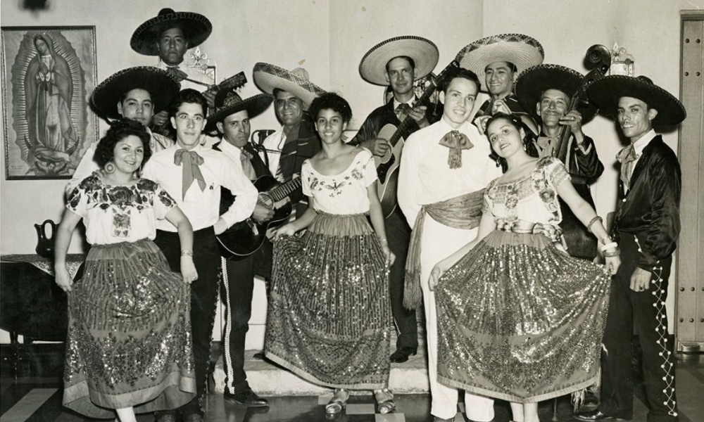 Photograph of dancers in traditional costumes and the Guadalupe Center Orchestra, circa 1941.