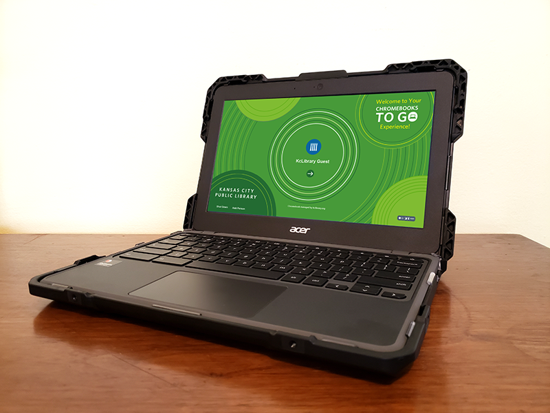 chromebook sitting on table with green screen