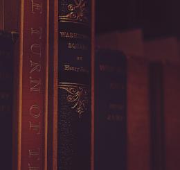 books on a shelf in dark light
