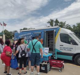 A group of people outside the bookmobile