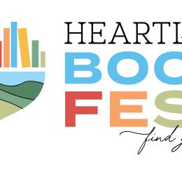 Heartland Book Fest with heart shaped out of books and a hill