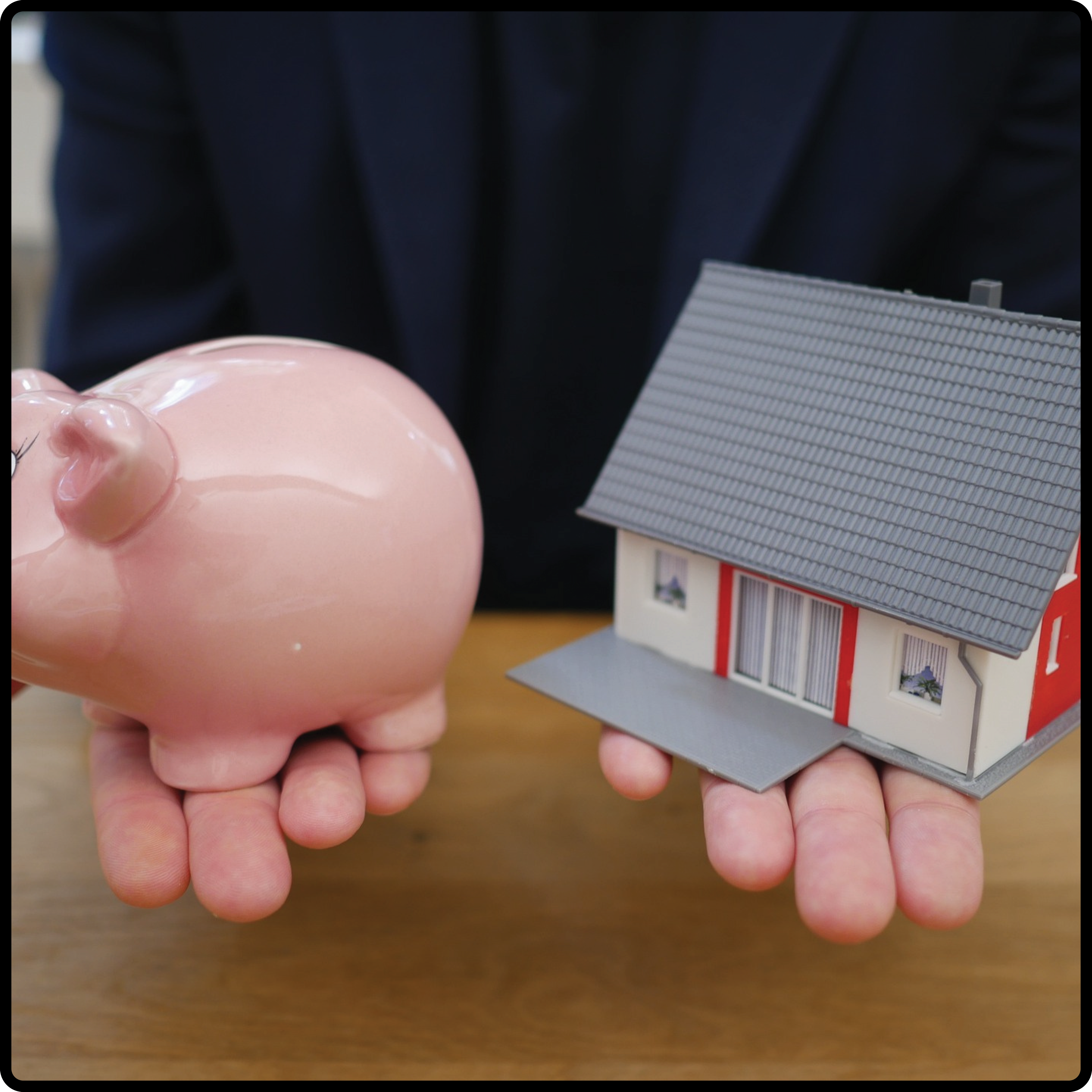 piggy bank and house in hands