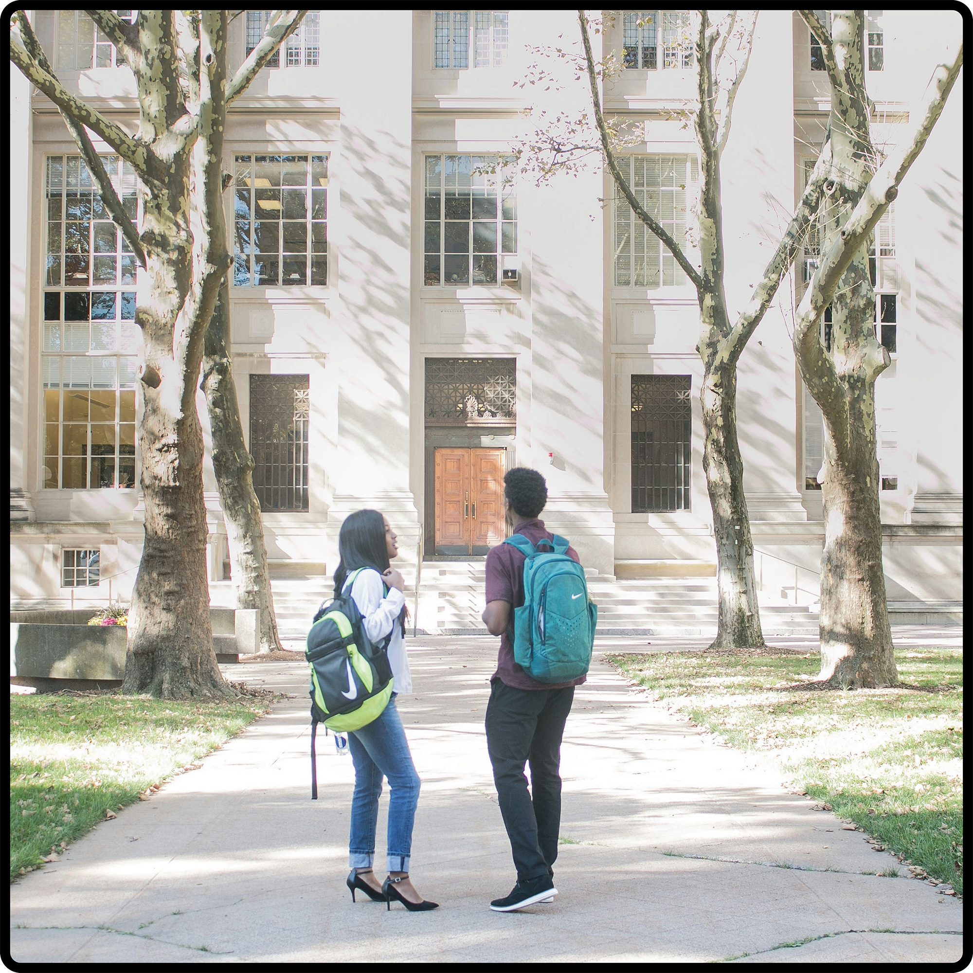 two students in front of college