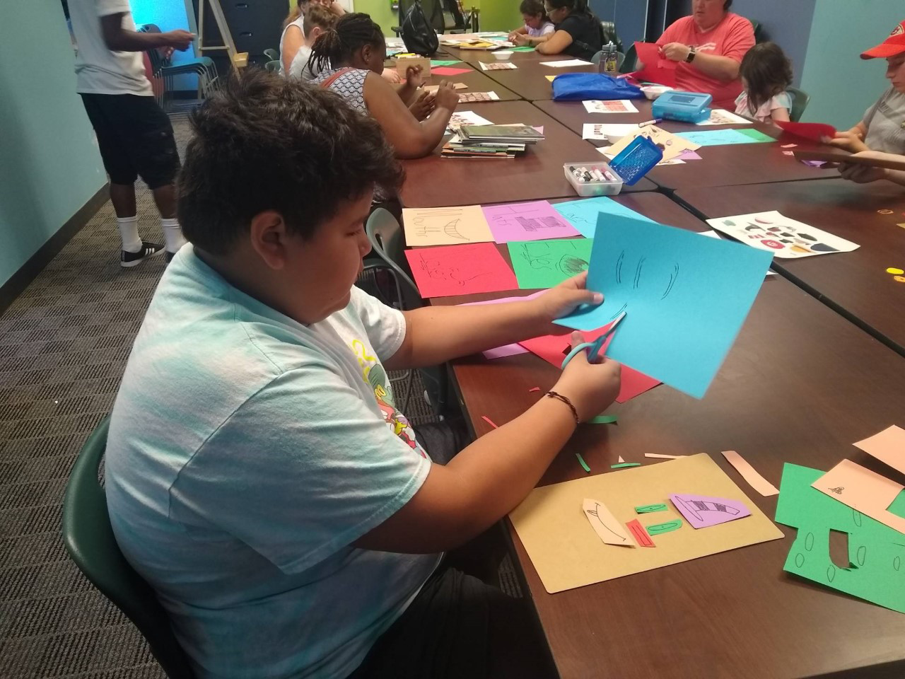 tween using scissors to cut paper