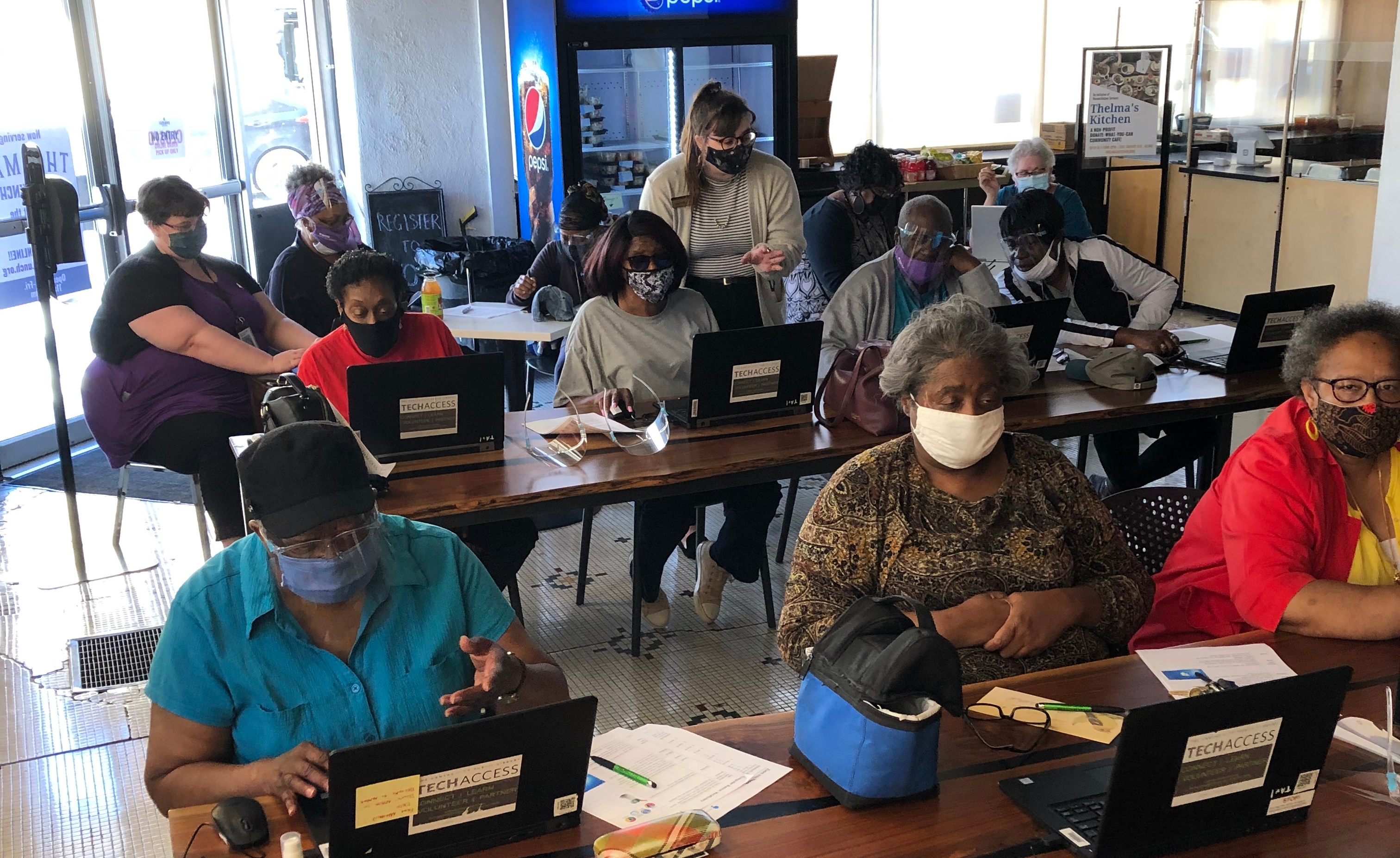 group of people taking a class on laptops