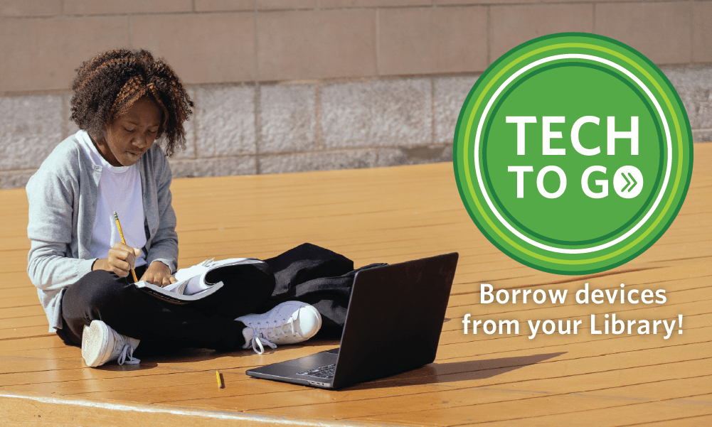 child sitting on floor next to laptop