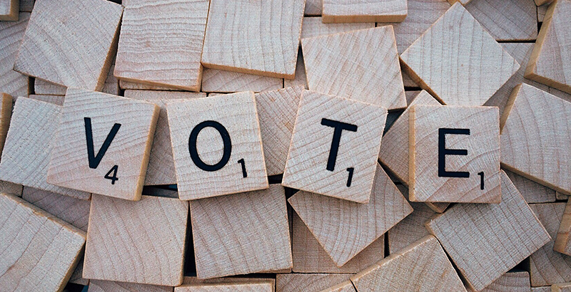 VOTE spelled with Scrabble tiles