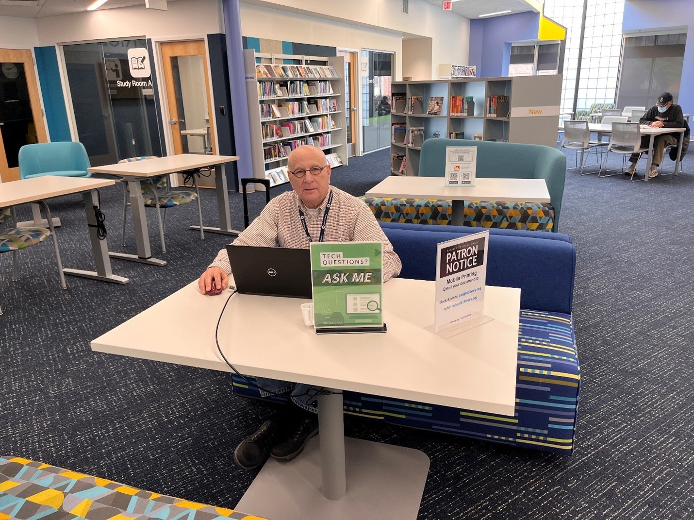 Man with a laptop sitting at a table