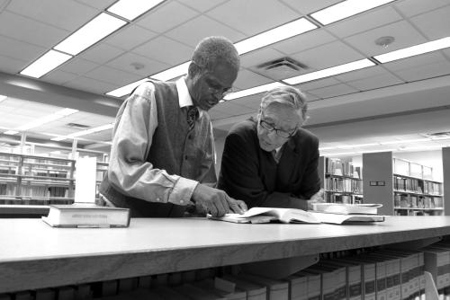 Two men looking at a book