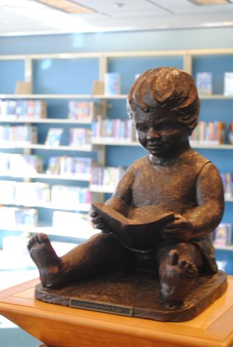 Child Reading on Pedestal