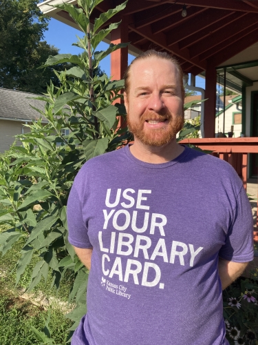 man standing outside near shrubs