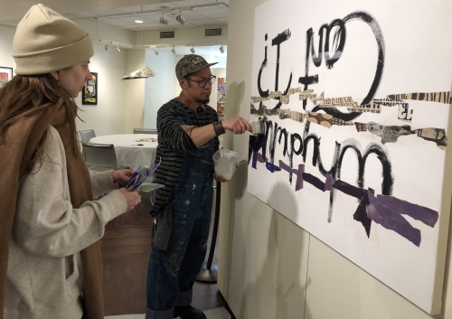 Justin Canja collaborates with a patron on an artwork in the Mountain Gallery at the Central Library.