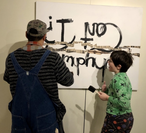 Artist Justin Canja collaborates on an artwork with a young patron named Thor in the Mountain Gallery at the Central Library.