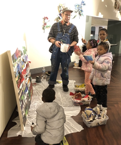 Kids gather around artist Justin Canja during a workshop at the Mountain Gallery in the Central Library.