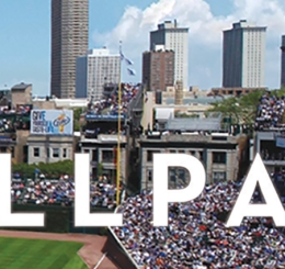 Photo of a crowded baseball stadium with skyline in the background