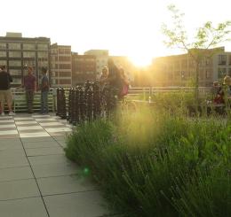 rooftop with groups of people and giant chess pieces
