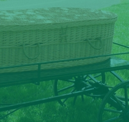 wicker casket on metal cart