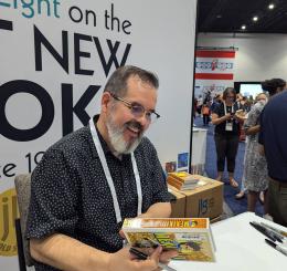 Pedro Martín signs books at the ALA. 