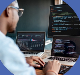 person in front of various montiors