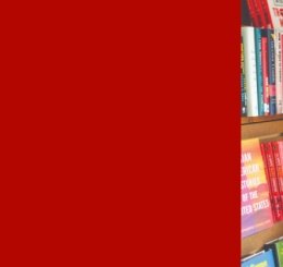 woman stands in front of books