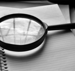 magnifying glass on notebook