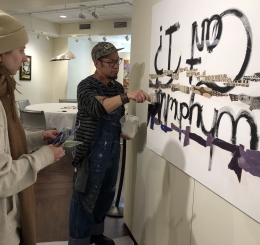 Justin Canja collaborates with a patron on an artwork in the Mountain Gallery at the Central Library.