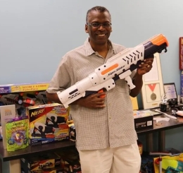 photo of man holding super soaker water gun