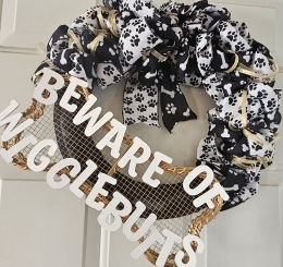 wreath with pawprints on ribbon