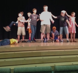 Students on stage, as instructor John Mulvey looks on, during the Young Actors Workshop at the Plaza Branch.