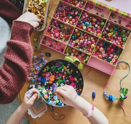 people making bracelets with beads