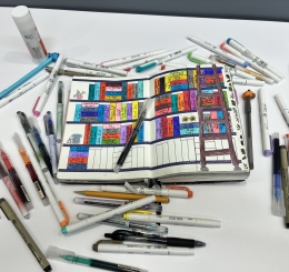 notebook with bookshelf drawn with pens and gluestick surrounding it