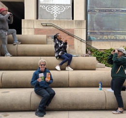4 people near staircase which looks likes books