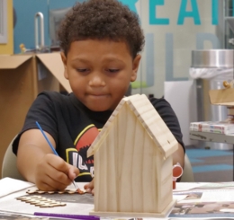 child with bird house and child flying kite