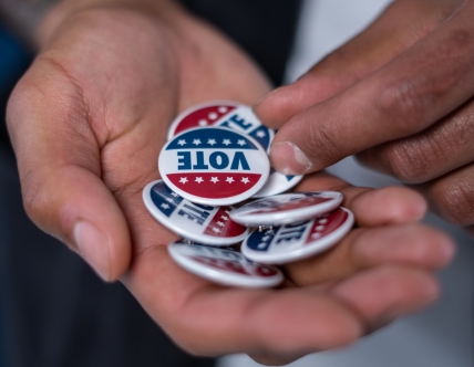 Hand filled with "vote" buttons