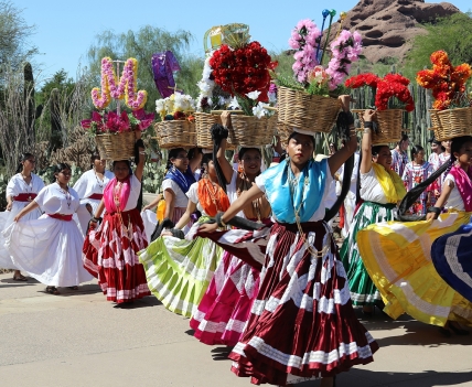dancers with baskets and flowers on heads