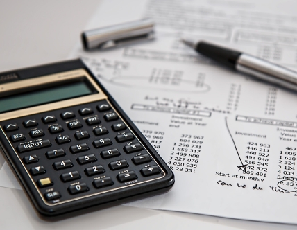 calculator and pen on paper