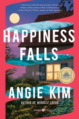 The cover of Happiness Falls has a dark pink background, with a ribbon that shows the front of a house as well as a body of water