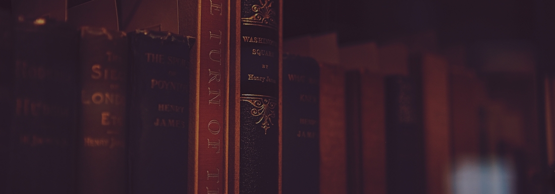 books on a shelf in dark light