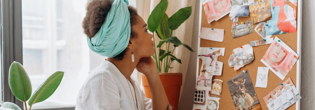 woman looks at vision board