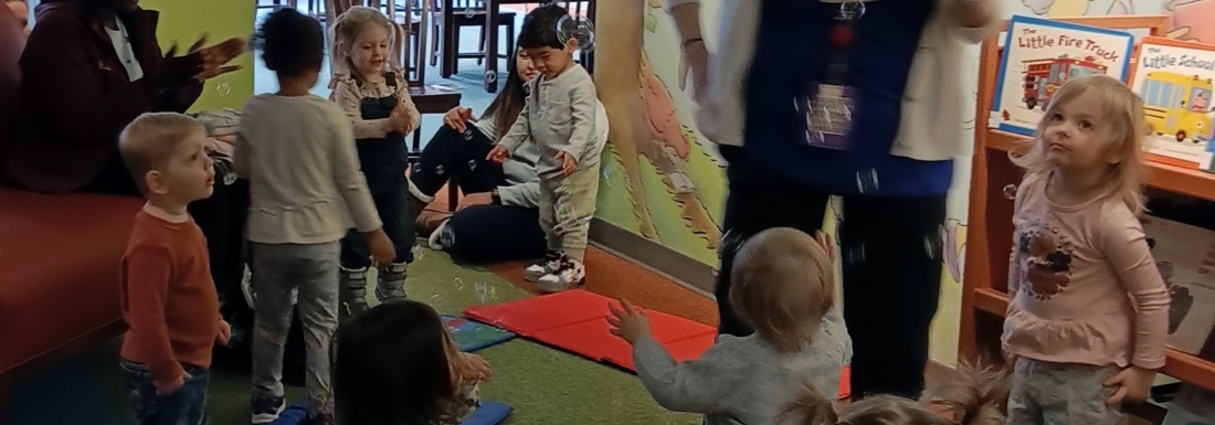 Children playing with bubbles in the library