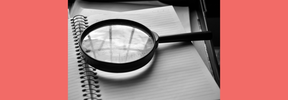 magnifying glass on notebook