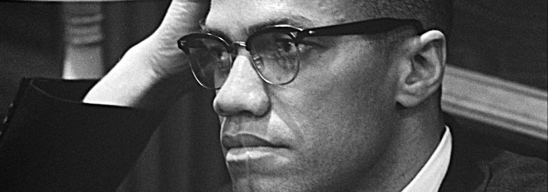 black and white photo of man with hand on head