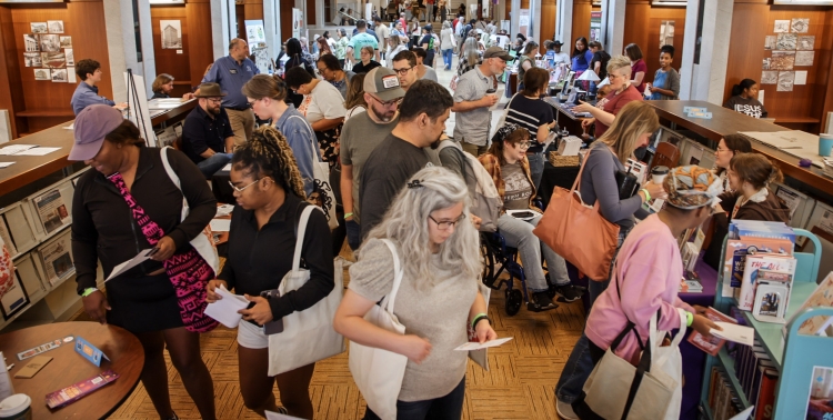 A crowd of people is gathered in a buliding.