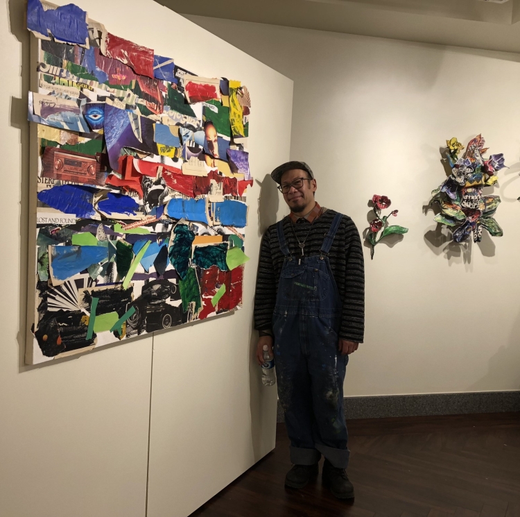 Artist Justin Canja stands with a collage work after the first workshop at the Mountain Gallery at the Central Library.