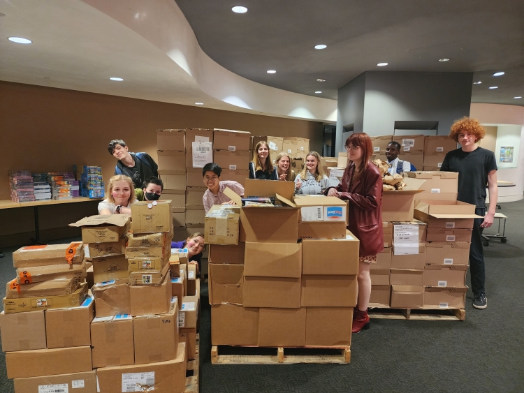 Teens with boxes of books 