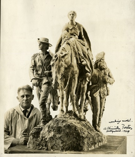 Photo of a sculptor working on a model of the "Pioneer Mother" statue