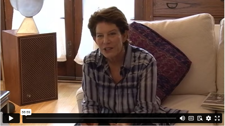 Artist Linda Lighton sits on a couch at home during an interview. 