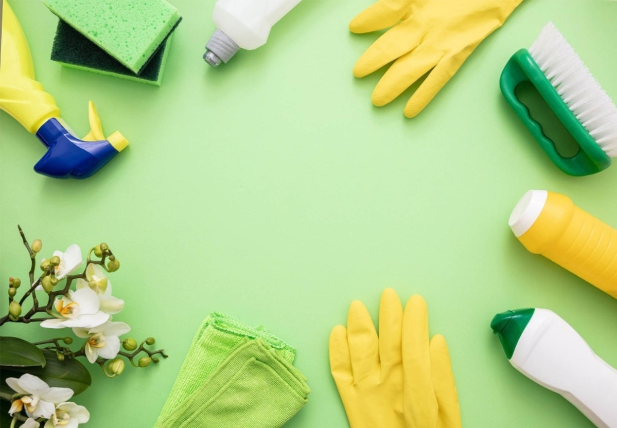 cleaning supplies on green background