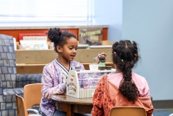 two girls playing at a table