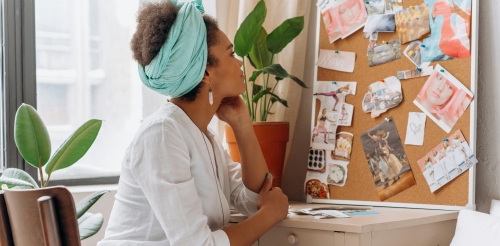 woman looks at vision board